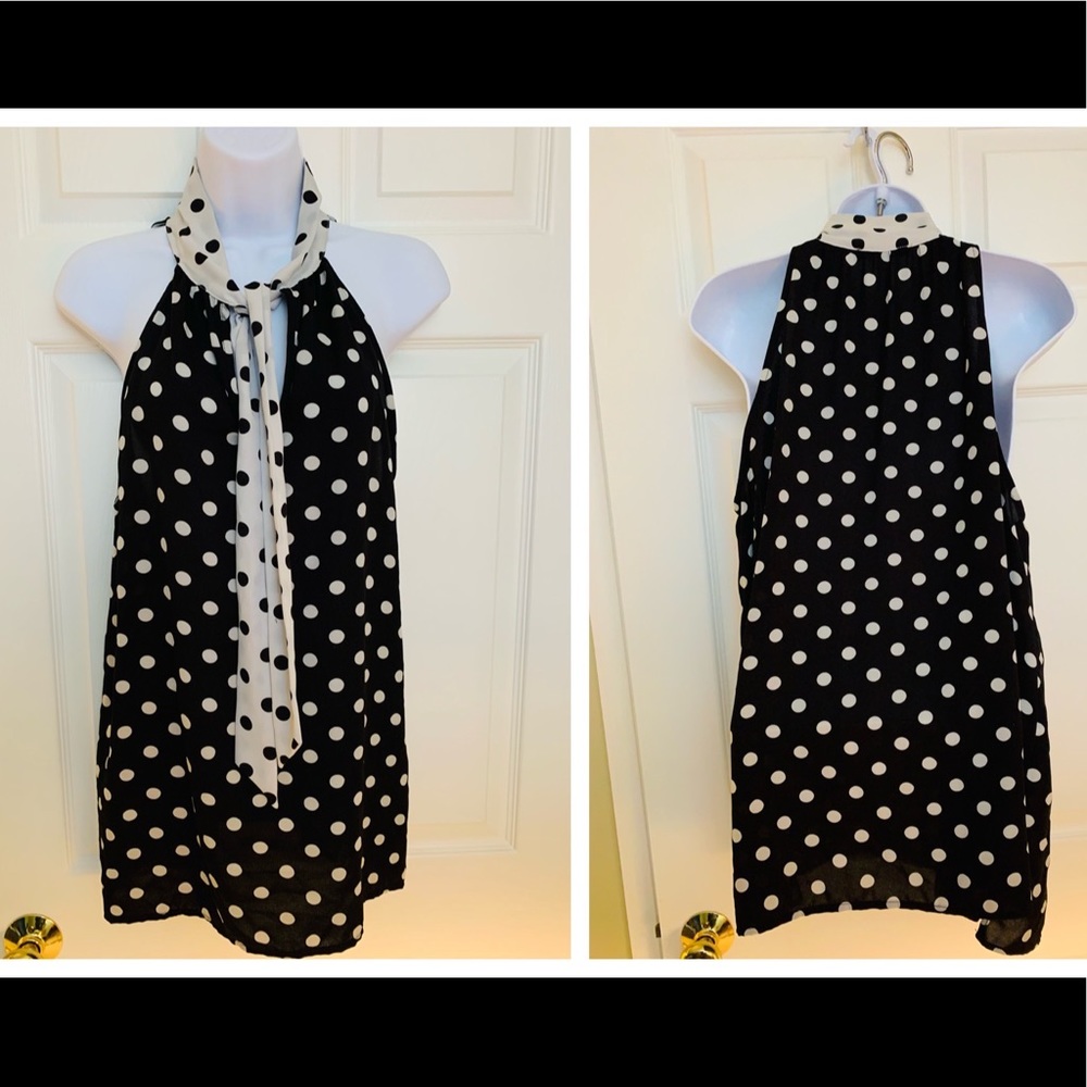Polka-dot sleeveless tie-neck top.